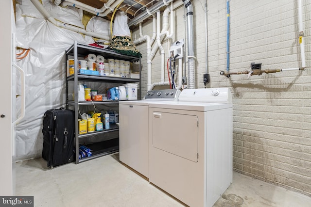 clothes washing area with independent washer and dryer