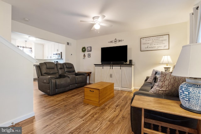 living room with hardwood / wood-style floors and ceiling fan