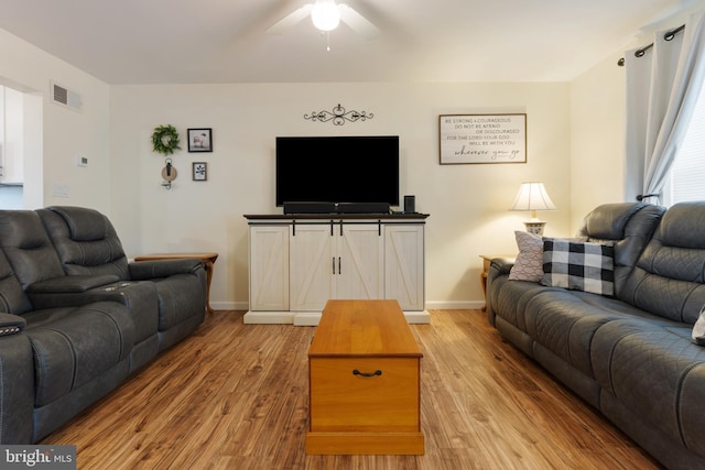 living room featuring light wood-type flooring and ceiling fan