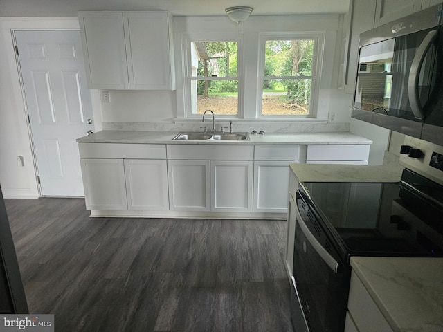 kitchen with white cabinetry, sink, dark wood-type flooring, and range with electric cooktop