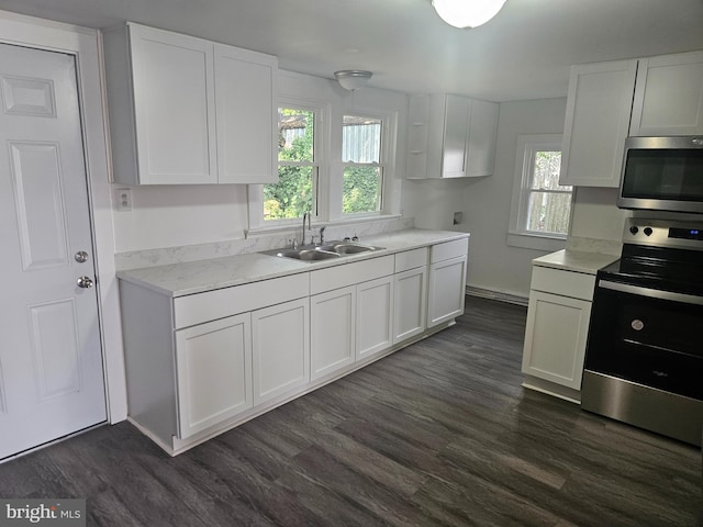 kitchen with sink, dark hardwood / wood-style flooring, white cabinets, and stainless steel appliances