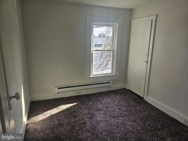 carpeted spare room with a baseboard radiator