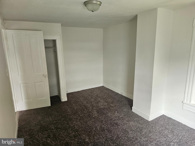 unfurnished bedroom with a closet and carpet floors