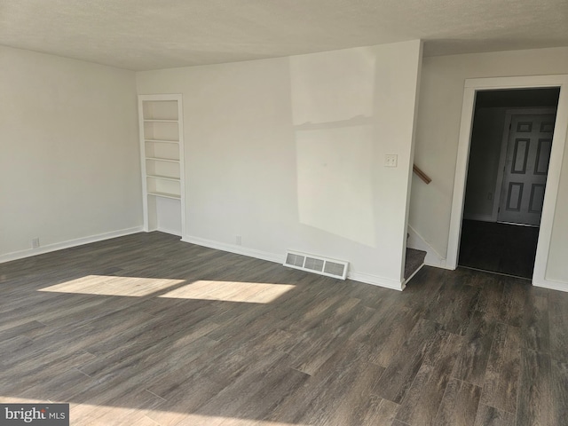 unfurnished room with dark hardwood / wood-style floors