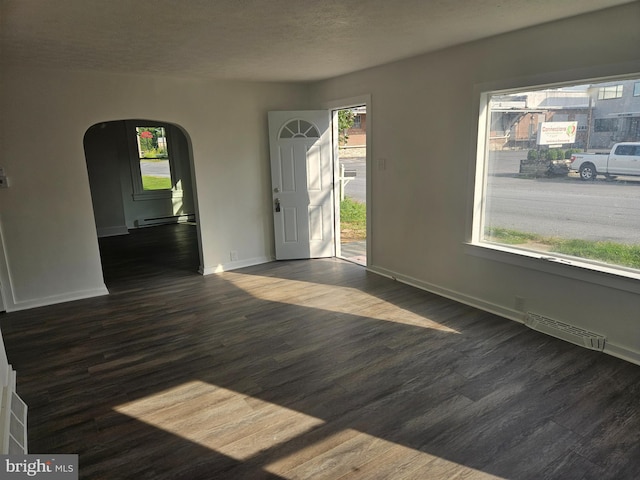 interior space featuring dark hardwood / wood-style flooring and baseboard heating