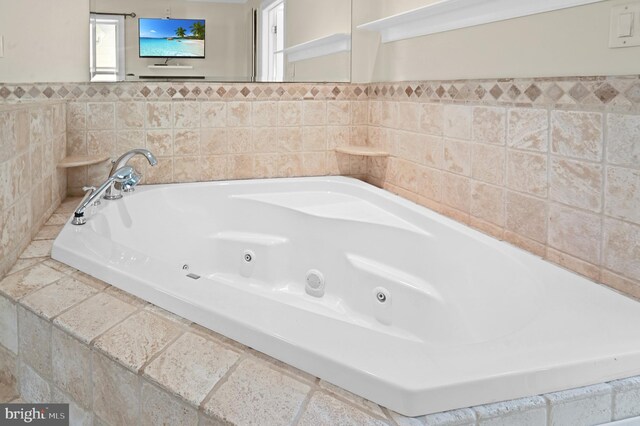 bathroom with tiled tub