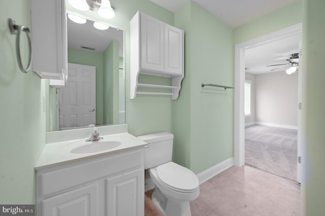 bathroom with ceiling fan, toilet, vanity, and tile patterned floors