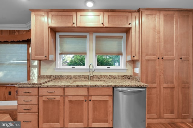 kitchen featuring light wood-style flooring, a sink, light stone countertops, dishwasher, and crown molding