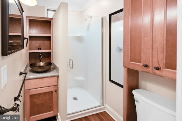 bathroom featuring toilet, vanity, ornamental molding, wood-type flooring, and walk in shower