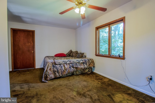 carpeted bedroom with ceiling fan and baseboards