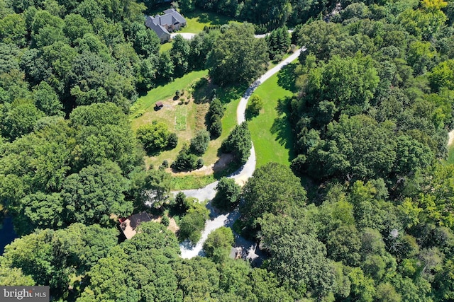 birds eye view of property with a view of trees