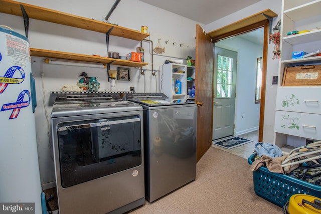 washroom featuring light colored carpet, laundry area, and washing machine and clothes dryer