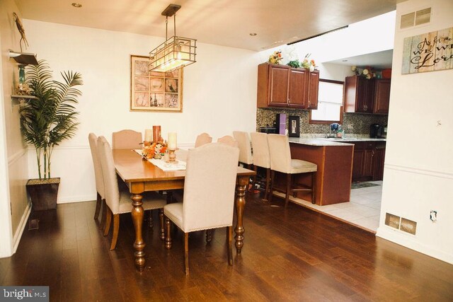 dining room featuring sink and light wood-type flooring