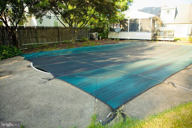 view of pool featuring a deck and a patio