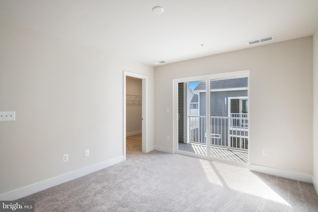 unfurnished room with light colored carpet