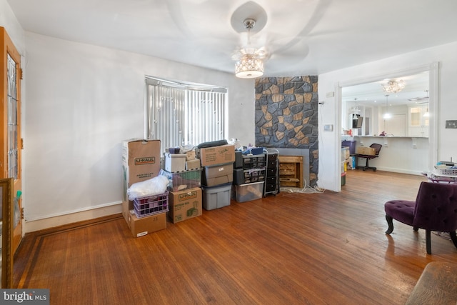 living area with hardwood / wood-style floors and ceiling fan