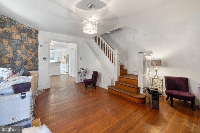 interior space with dark wood-type flooring and ceiling fan