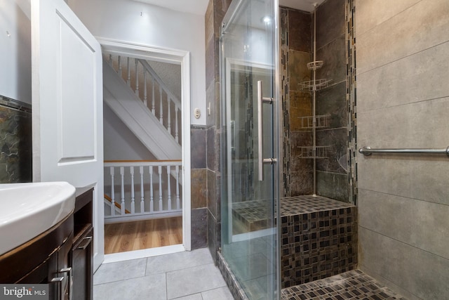 bathroom featuring wood-type flooring, an enclosed shower, and vanity