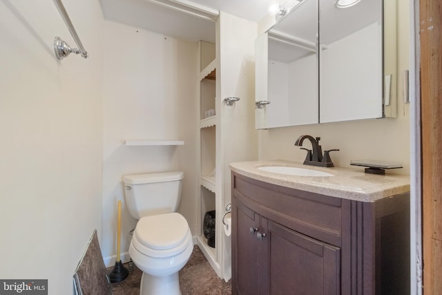 bathroom featuring toilet and vanity