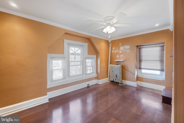 additional living space featuring radiator heating unit, dark hardwood / wood-style flooring, and ceiling fan