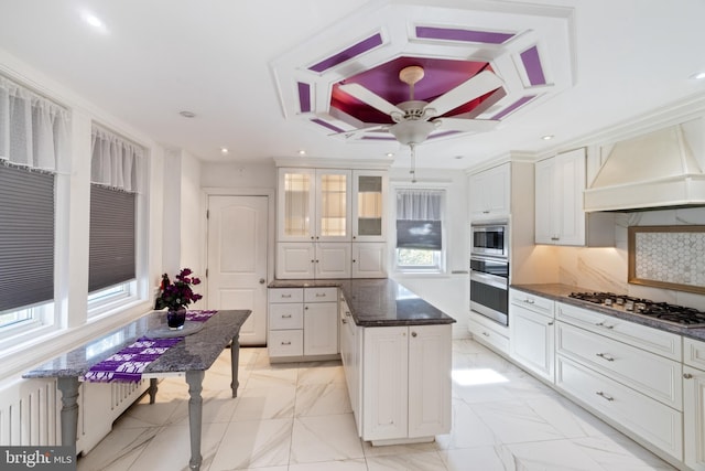 kitchen with a center island, white cabinetry, recessed lighting, stainless steel appliances, and decorative backsplash