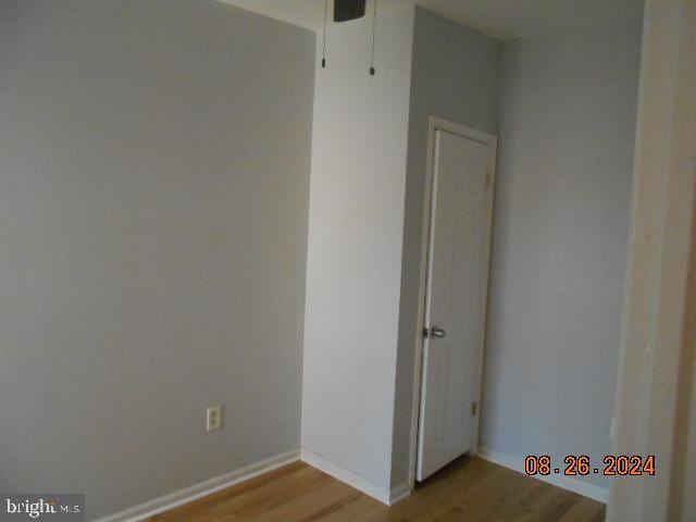 empty room with baseboards and light wood-style floors