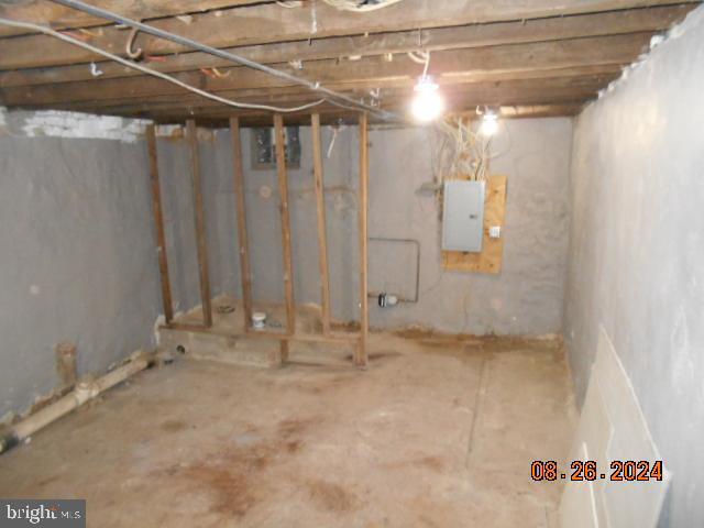 unfinished basement featuring electric panel