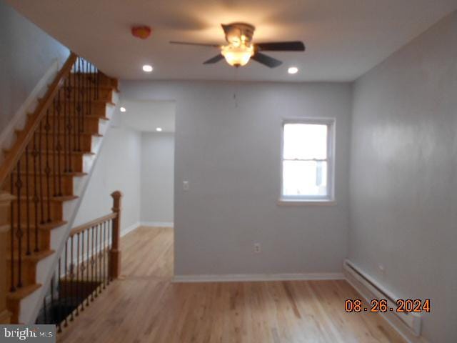 unfurnished room featuring ceiling fan and light wood-type flooring