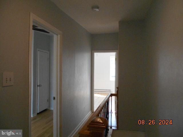 corridor with wood-type flooring