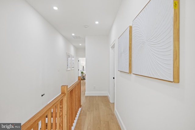 hallway with light hardwood / wood-style flooring