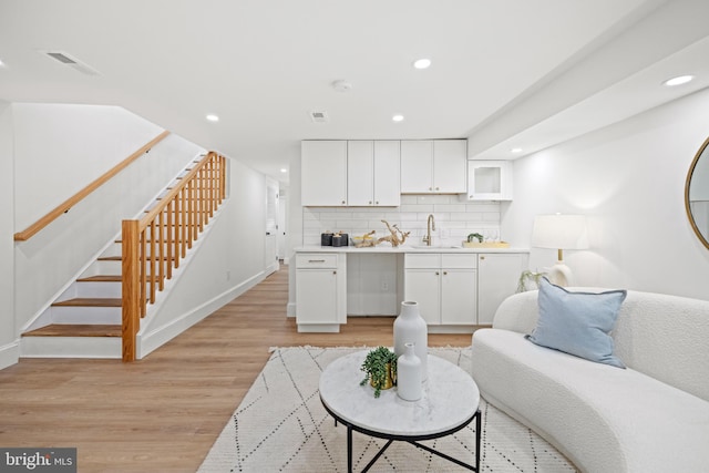 living room with sink and light hardwood / wood-style floors