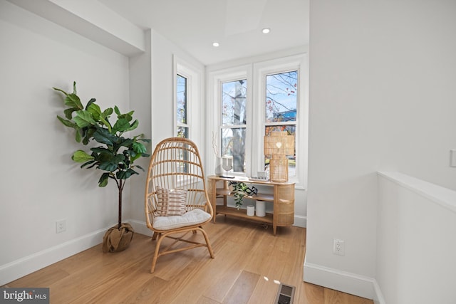 sitting room featuring light hardwood / wood-style flooring