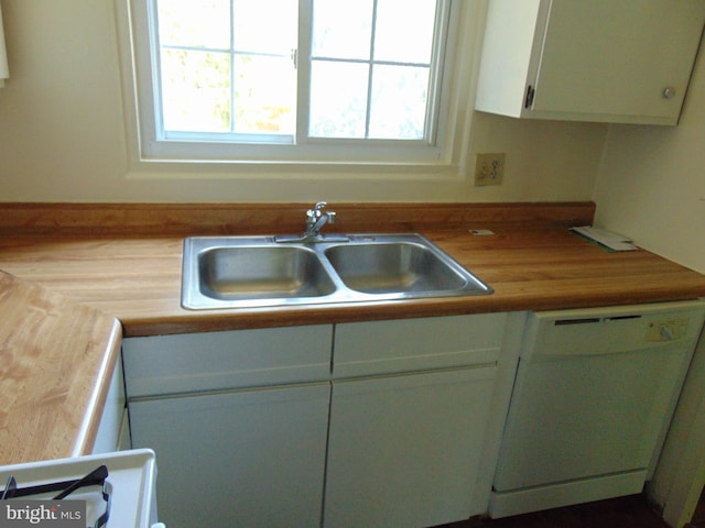 kitchen with range, white cabinetry, butcher block countertops, dishwasher, and sink