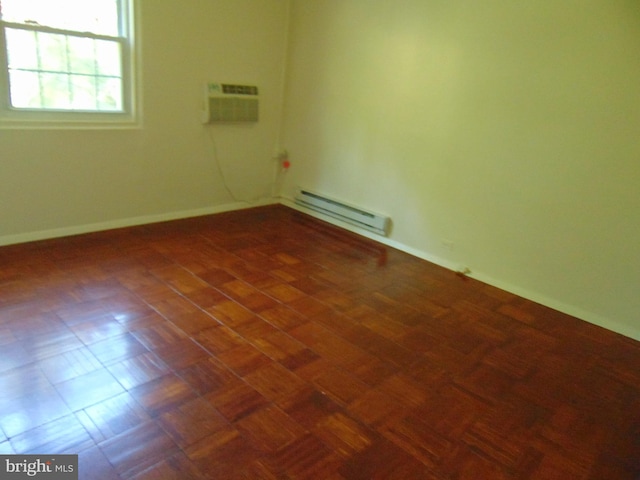 empty room with a wall mounted AC, baseboards, and a baseboard radiator