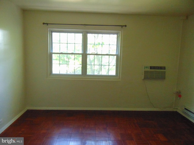 empty room with a healthy amount of sunlight, an AC wall unit, baseboards, and a baseboard radiator