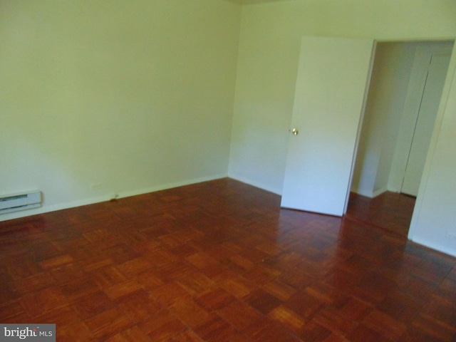 empty room featuring dark parquet flooring