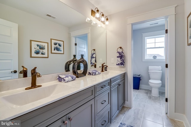 bathroom with tile patterned flooring, toilet, and vanity