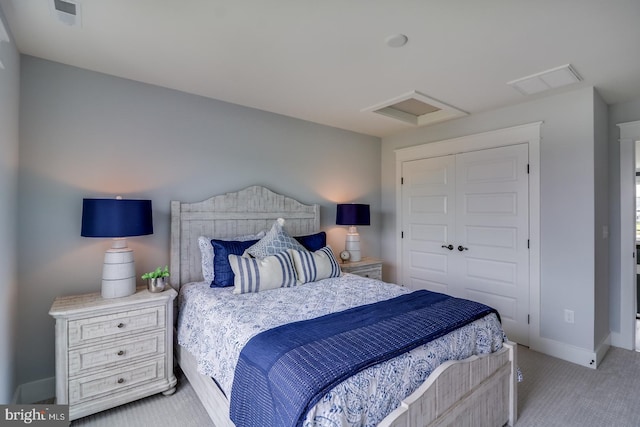 bedroom with light carpet, attic access, baseboards, visible vents, and a closet