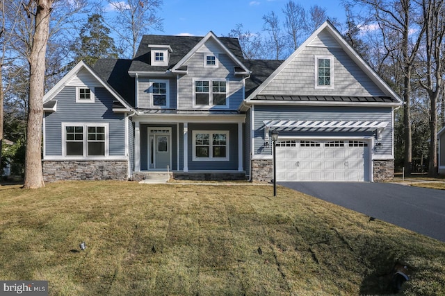 craftsman house with a garage, a porch, and a front yard