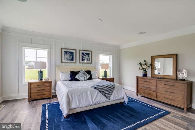 bedroom featuring hardwood / wood-style flooring and crown molding