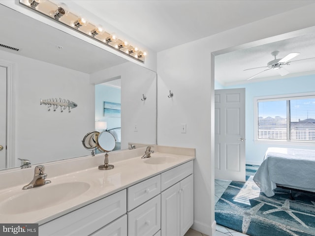 bathroom with tile patterned flooring, vanity, and ceiling fan