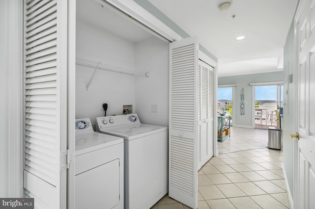 laundry room featuring light tile patterned floors and washer and clothes dryer