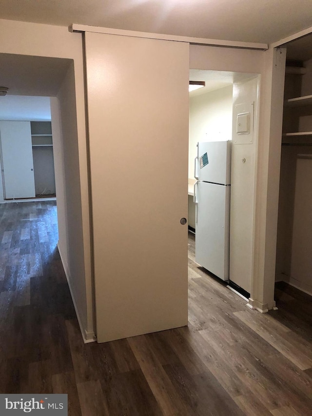 hallway with hardwood / wood-style flooring