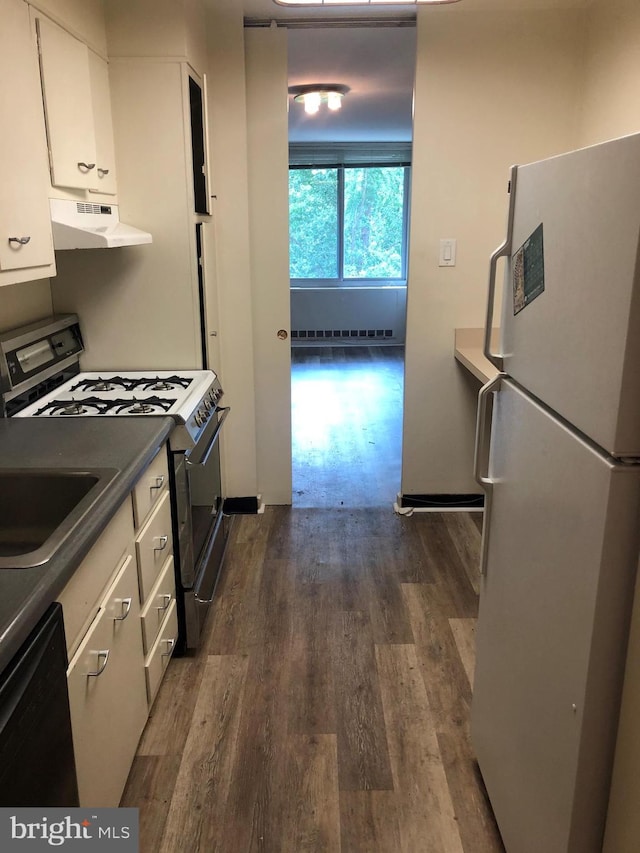 kitchen featuring black dishwasher, freestanding refrigerator, range hood, white cabinetry, and gas stove