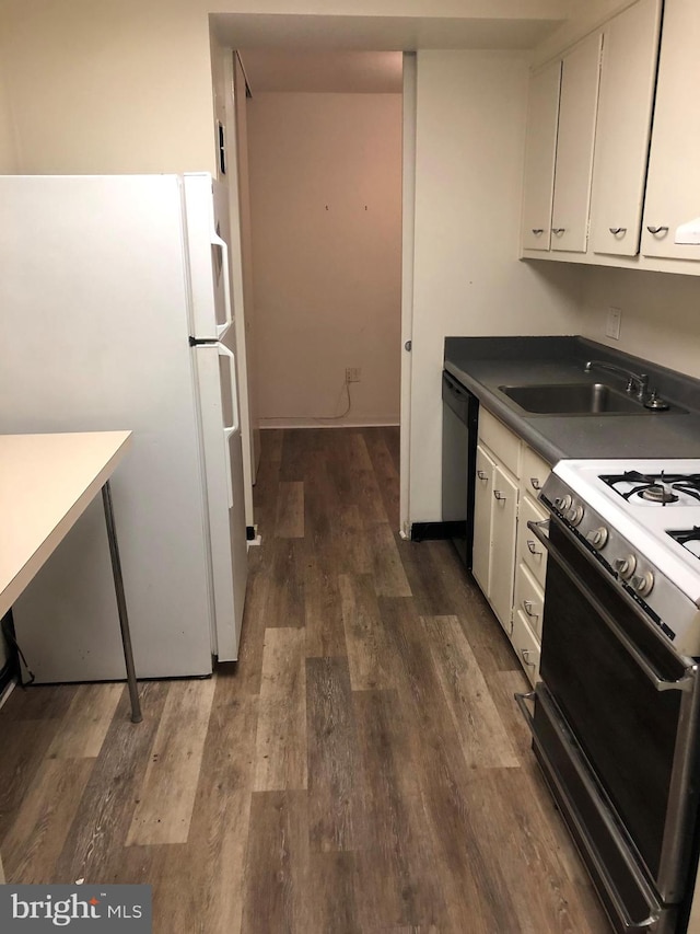 kitchen with sink, white appliances, white cabinets, and dark hardwood / wood-style flooring