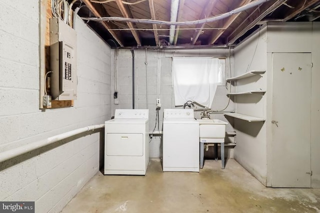 basement featuring electric panel and washing machine and dryer