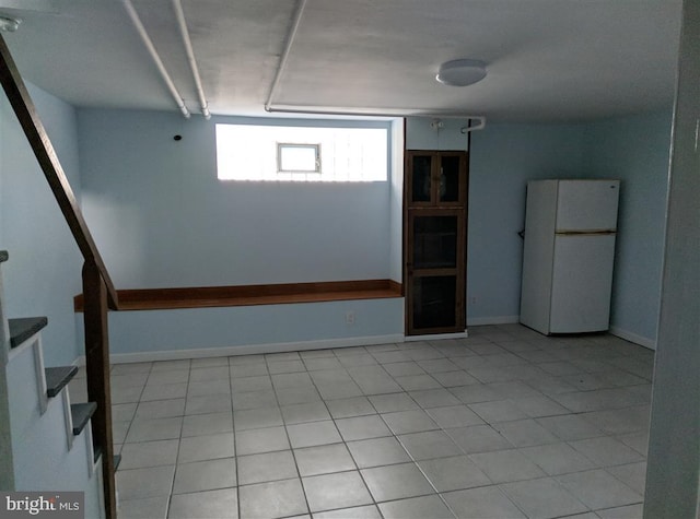 spare room featuring light tile patterned flooring