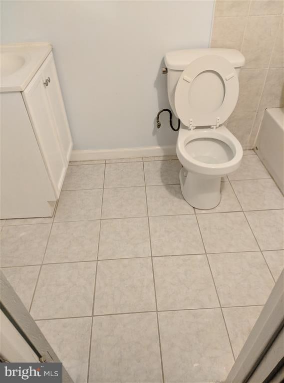 bathroom with tile patterned floors, vanity, and tile walls