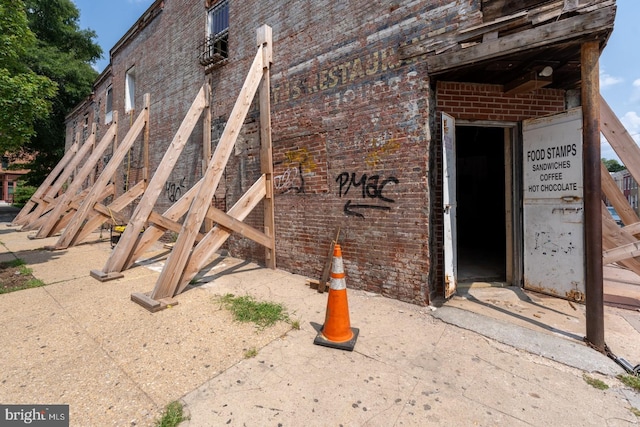 view of side of home with brick siding