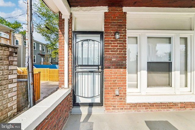 doorway to property with brick siding